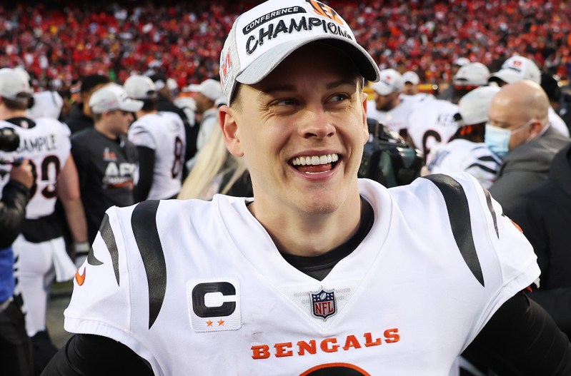 Joe Burrow with a smile in his face wearing his uniform on the field after winning the AFC championship game