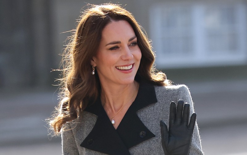 Kate Middleton wears a gray coat with a black trim and gloves during a trip to Denmark