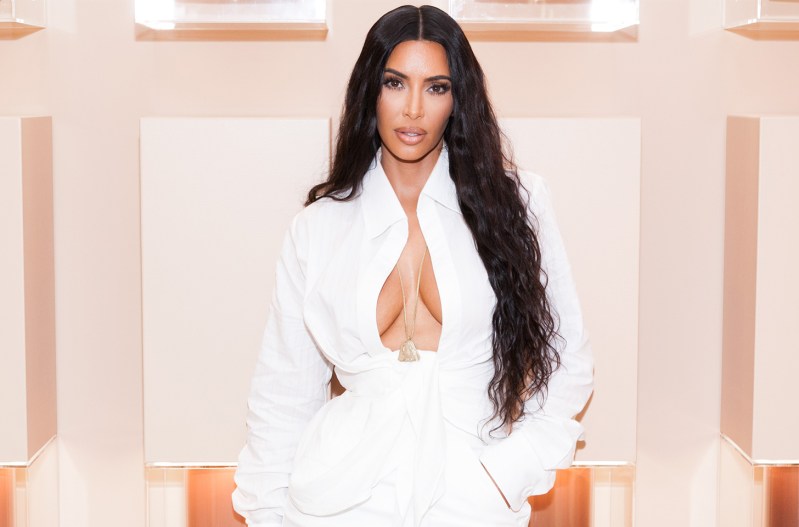 Kim Kardashian in all white with a very low cut top.