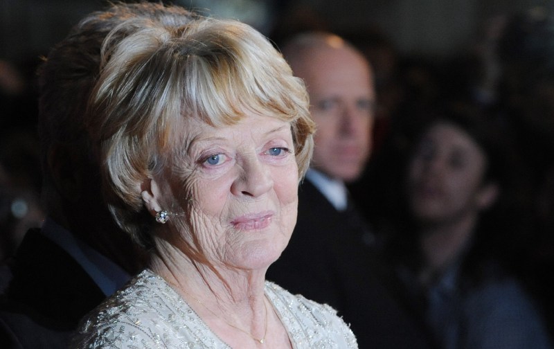 Maggie Smith wears a white dress on the red carpet