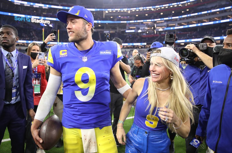 Matthew Stafford and Kelly Stafford celebrating on the field after the Rams won the NFC Championship