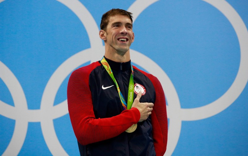 Michael Phelps holds his hand over his heart during the USA national anthem at the Olympics