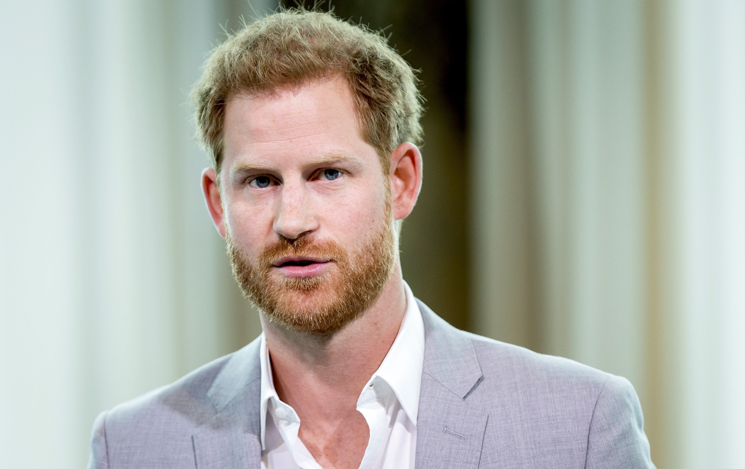 Prince Harry wears a light colored suit