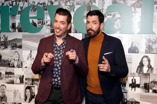 Jonathan Scott on the left, pointing to the camera, standing next to Drew Scott on the right