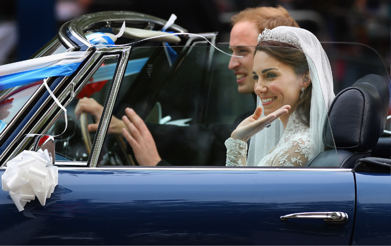 Prince William and Kate Middleton drive through a crowd of well wishers following their 2011 wedding