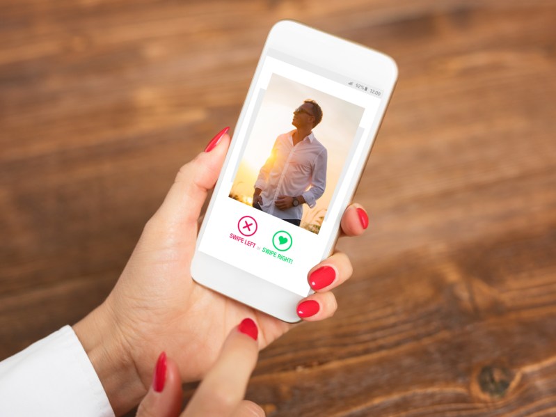 Woman using dating app and swiping user photos