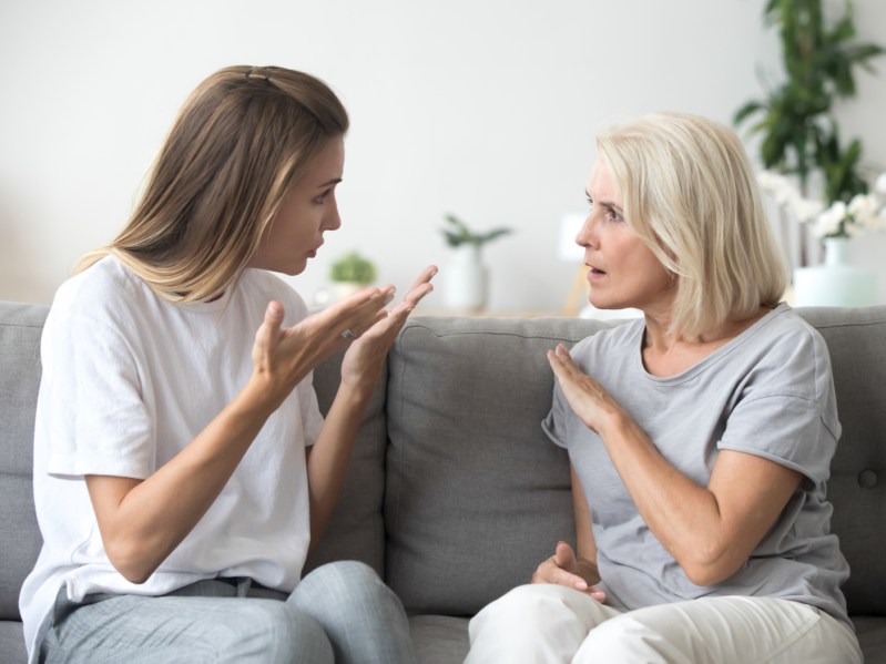 Angry young woman has disagreement with annoyed old mother in law, grown daughter arguing fighting quarreling with senior elderly mom, different age generations bad relations family conflict concept