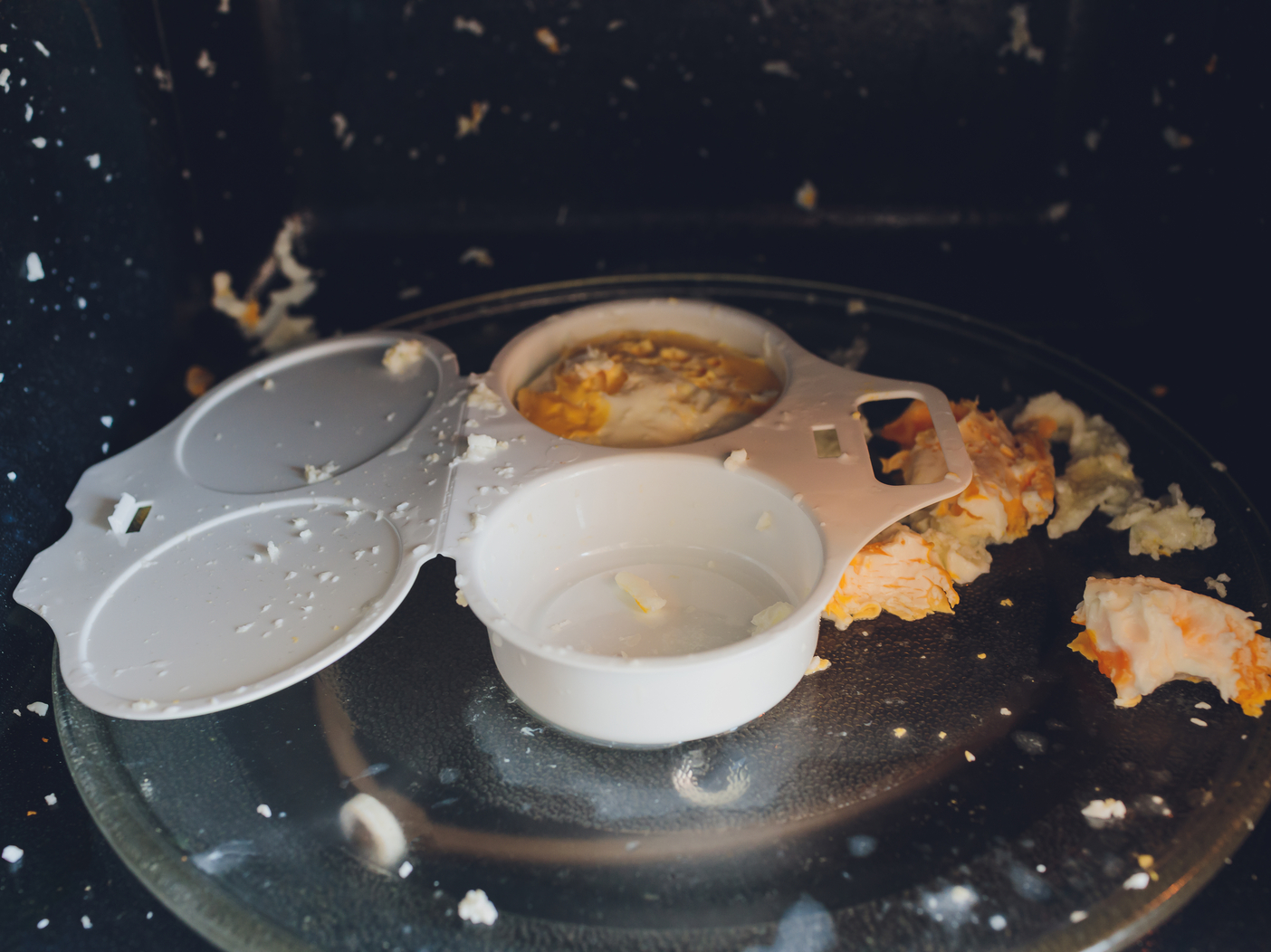Egg blast in microwave top view. Fragment of a plastic container for egg cooking in microwave oven.