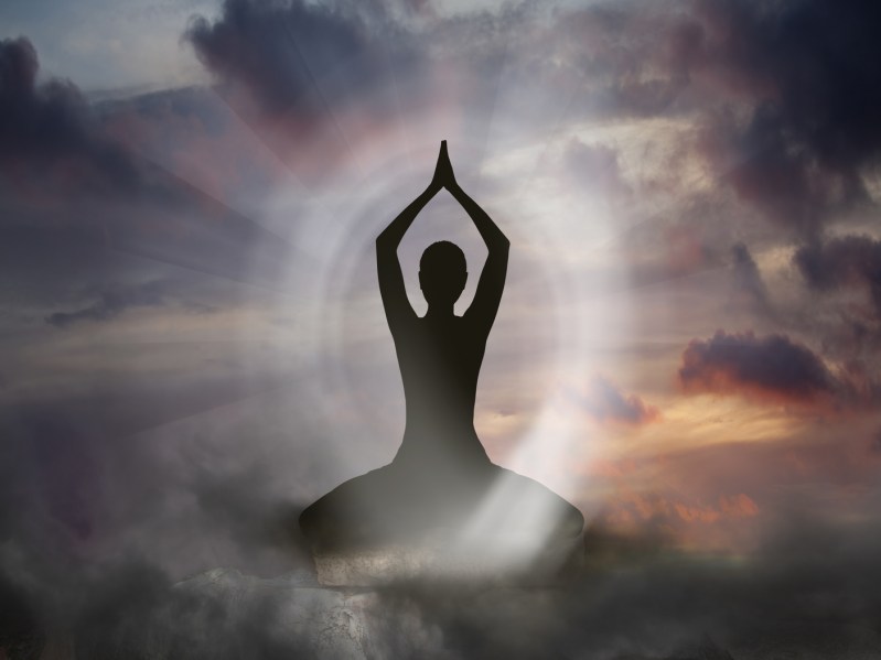Yoga and Spirituality image with a shadow woman surrounded by whisps of gray