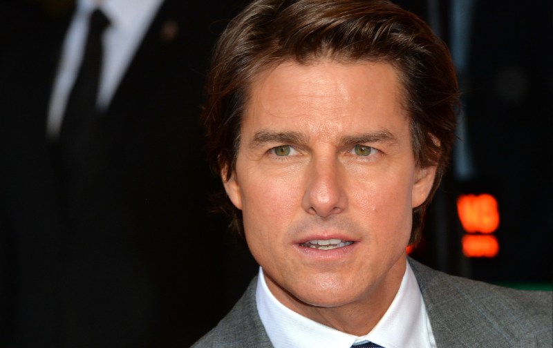 Tom Cruise wears a gray suit at a film premiere