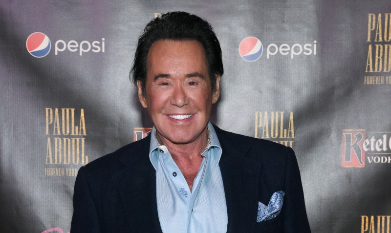 Wayne Newton smiling in a blue suit