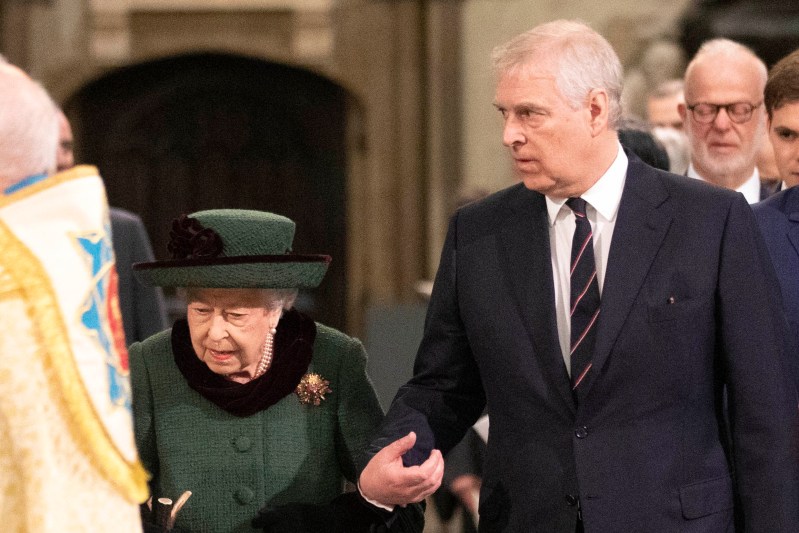 Queen Elizabeth, in a green hat and coat, is escorted by son Prince Andrew, in a black suit