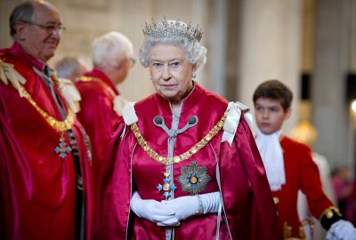 Queen Elizabeth wearing crown and deep red robes