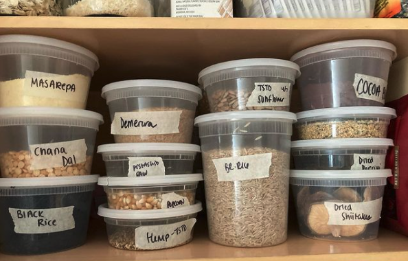 Various spices and dry pantry items in deli containers.