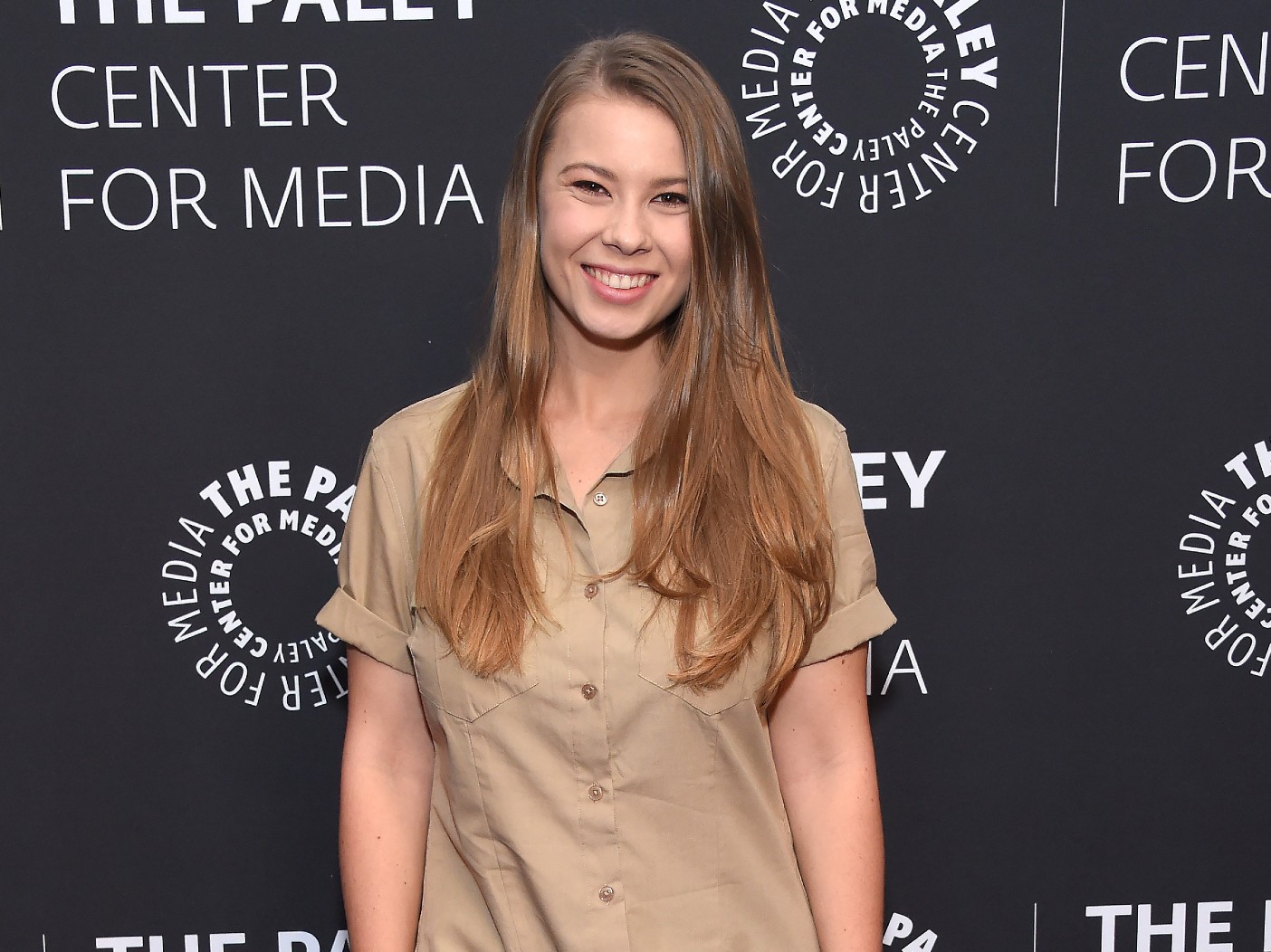Bindi Irwin wearing a tan button-down