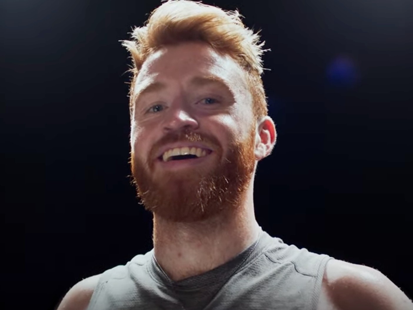 Daniel McKenna smiling in gray tank top