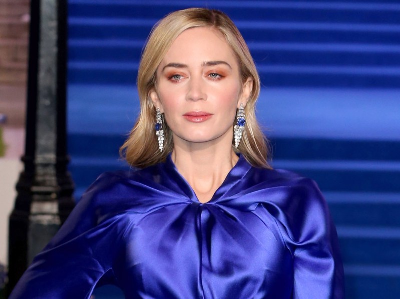 Emily Blunt wears a long indigo colored gown on the red carpet