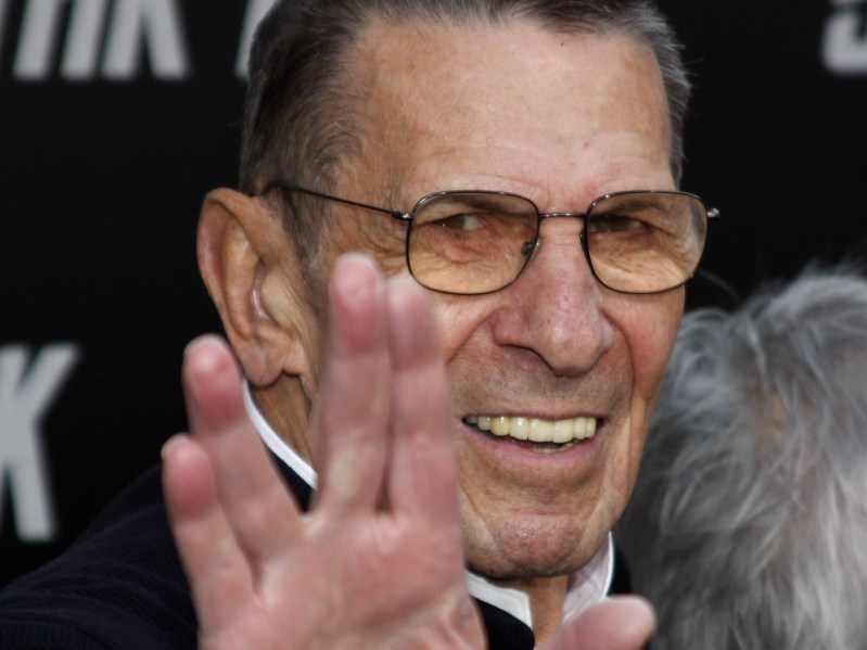 Leonard Nimoy smiling and making the live long and prosper sign with his hand