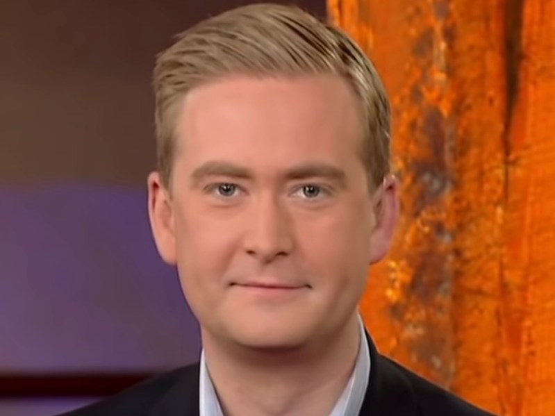 Screenshot from Fox News of Peter Doocy smiling at camera wearing suit jacket