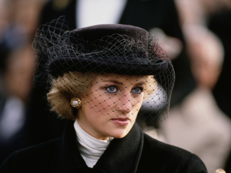 Princess Diana wearing an all black outfit looking solemnly off camera
