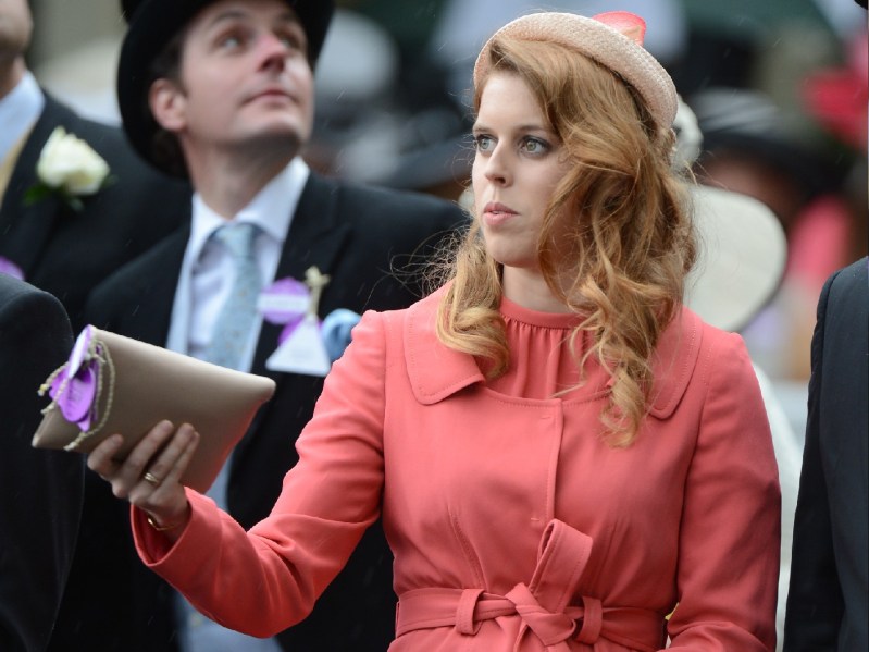 Princess Beatrice wears a bright salmon outfit as she walks during a royal event