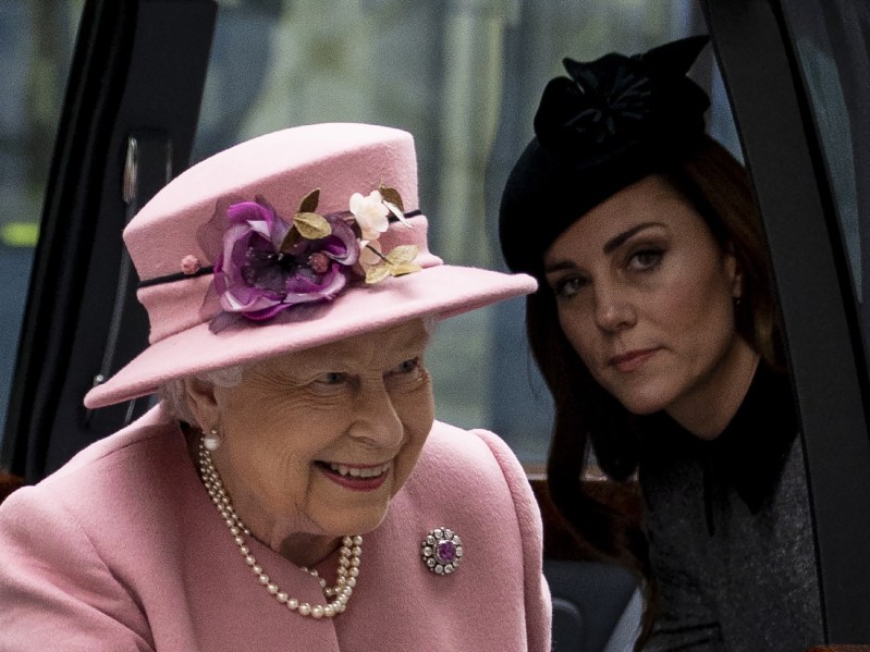 Queen Elizabeth, in pink, and Kate Middleton, in dark clothing, exit a car together