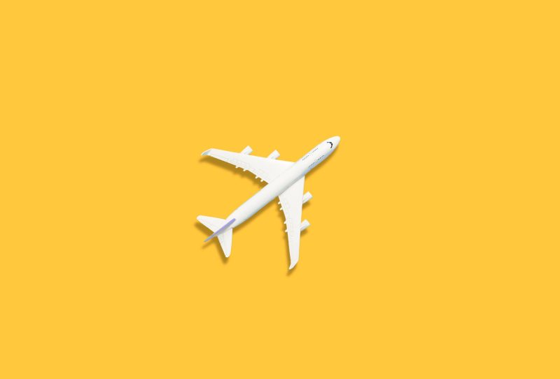 White airplane on a yellow background.
