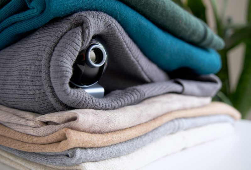 Small camera hidden in a stack of folded clothes.