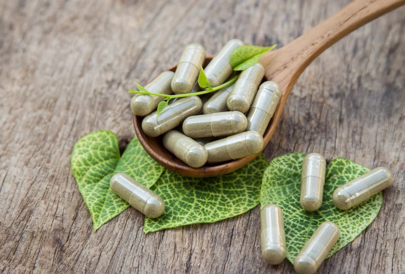 Herbal supplements on a decorative background