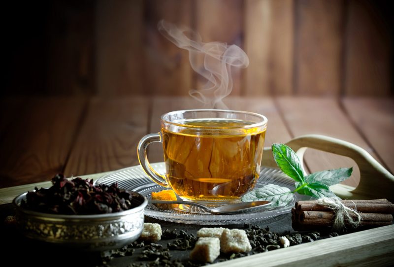 A clear mug of hot, herbal tea