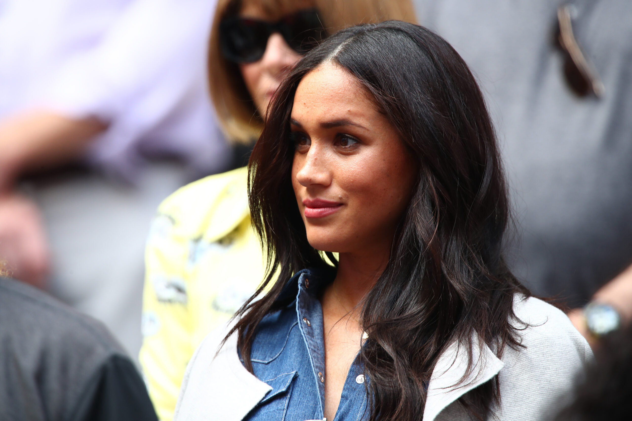 Meghan Markle rocking smooth, shiny hair at a tennis match.