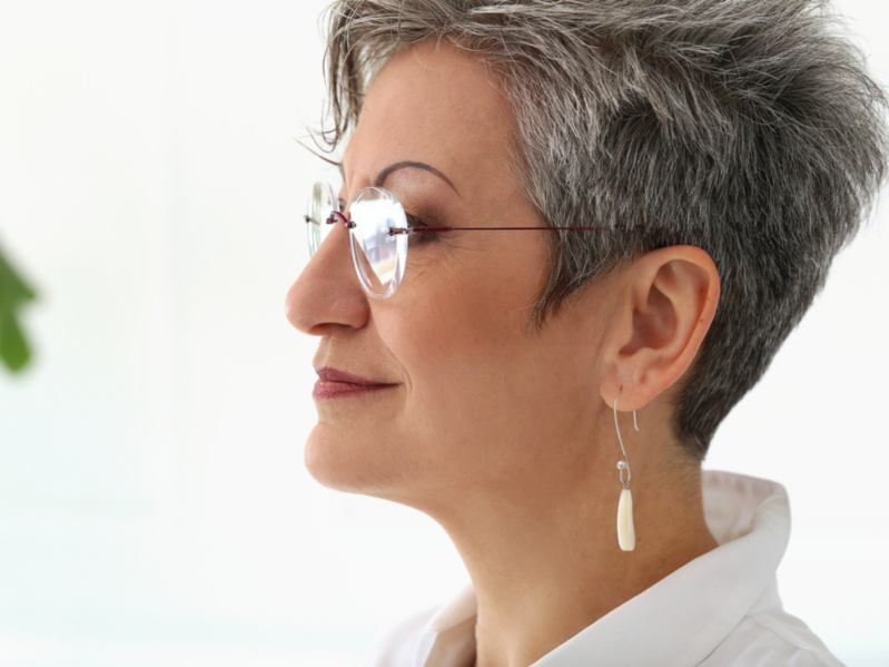 Older woman profile wearing large dangle earrings