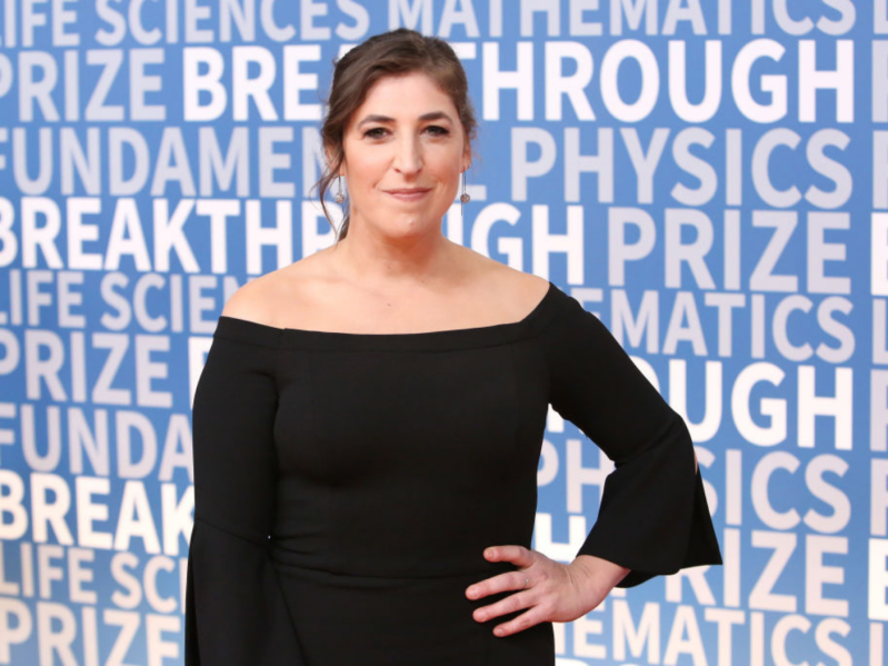Mayim Bialik at event, hand on hip, closed smile