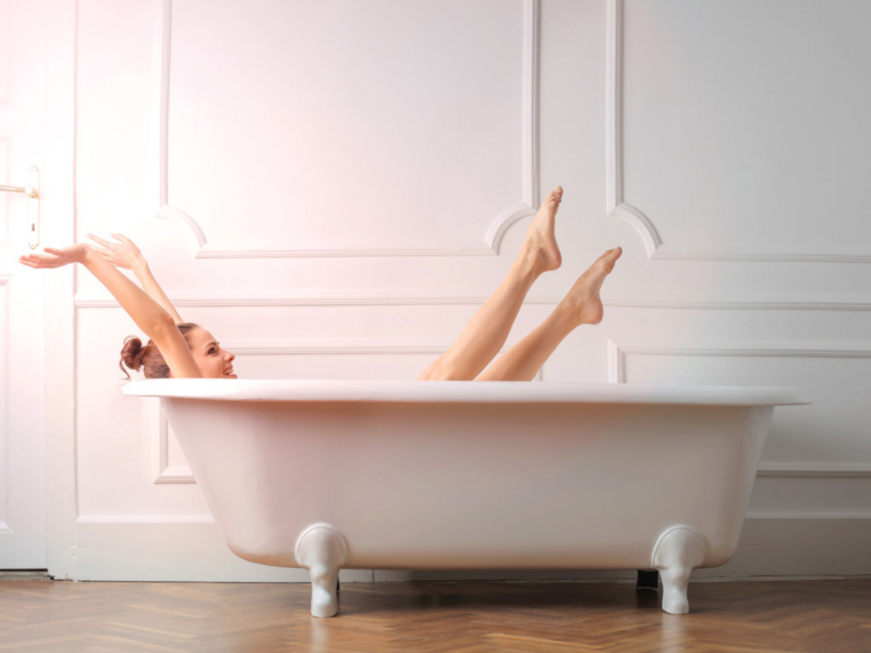 Woman relaxes in bath tub, reduces inflammation and burns calories
