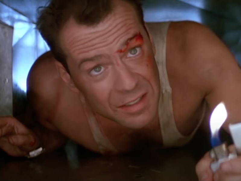 Still frame from Die Hard, closeup of Bruce Willis holding a lighter
