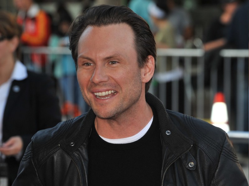 Christian Slater wears a dark jacket over a black top on the red carpet