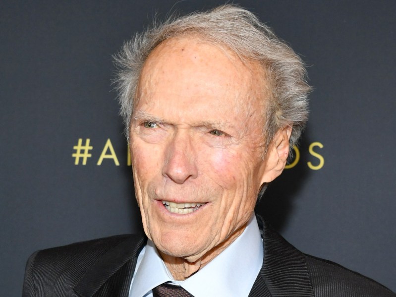 Closeup of Clint Eastwood wearing suit smiling off-camera