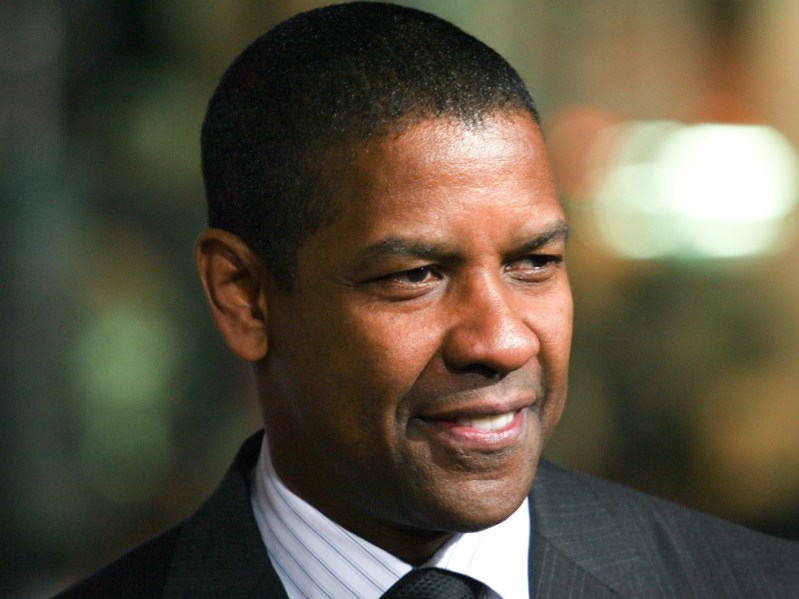Closeup of Denzel Washington smiling with teeth off-camera