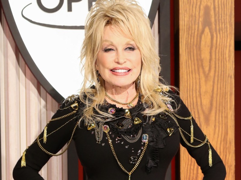 Closeup of Dolly Parton wearing black and gold jumpsuit
