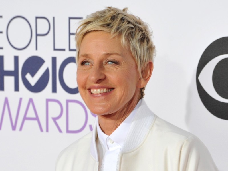 Ellen Degeneres smiling wearing all-white suit