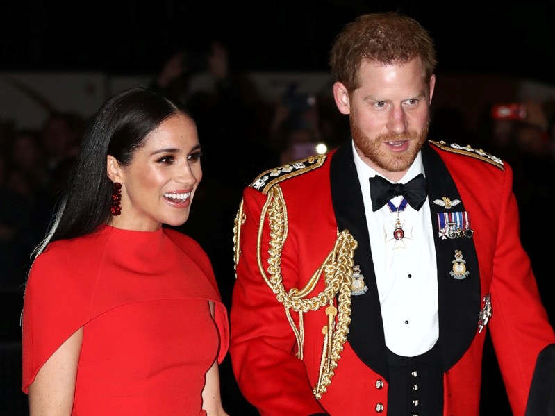 Meghan Markle and Prince Harry wearing red and black