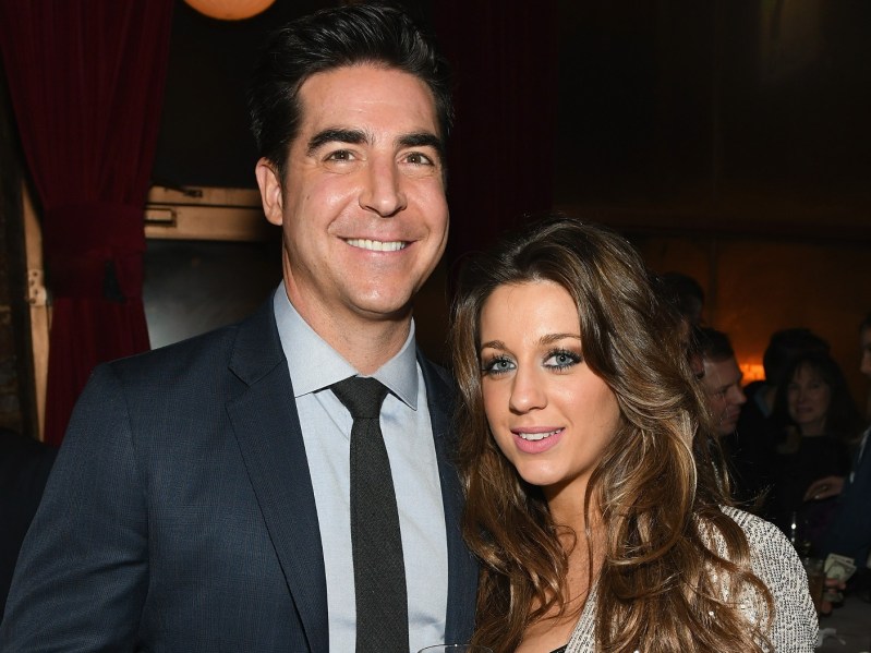 Jesse Watters (L) wearing navy suit and tie, pictured with his wife