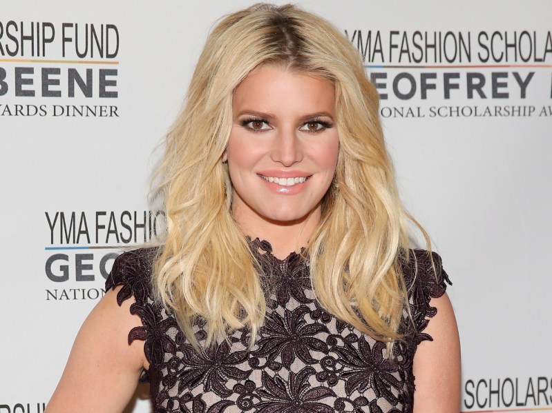 Jessica Simpson with hair down in middle part, wearing lace overlay dress