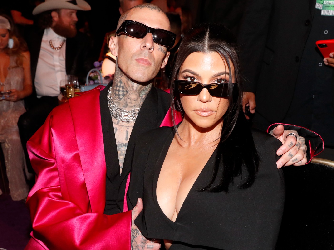 Travis Barker and Kourtney Kardashian wearing sunglasses