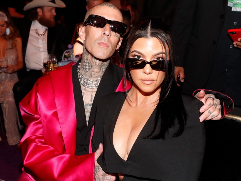 Travis Barker and Kourtney Kardashian wearing sunglasses