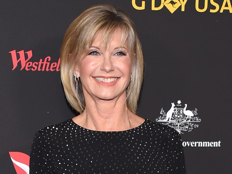 Olivia Newton-John wears a black dress on the red carpet