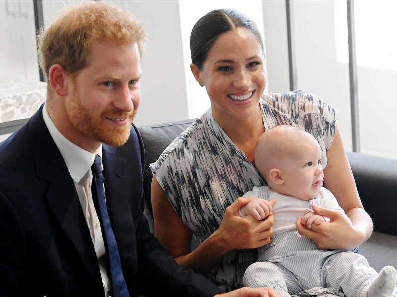Prince Harry, Meghan Markle, and their son Archie cuddle together on a couch