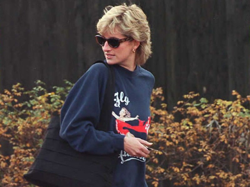 Princess Diana wears sunglasses and a sweatshirt as she is caught outdoors by photographers
