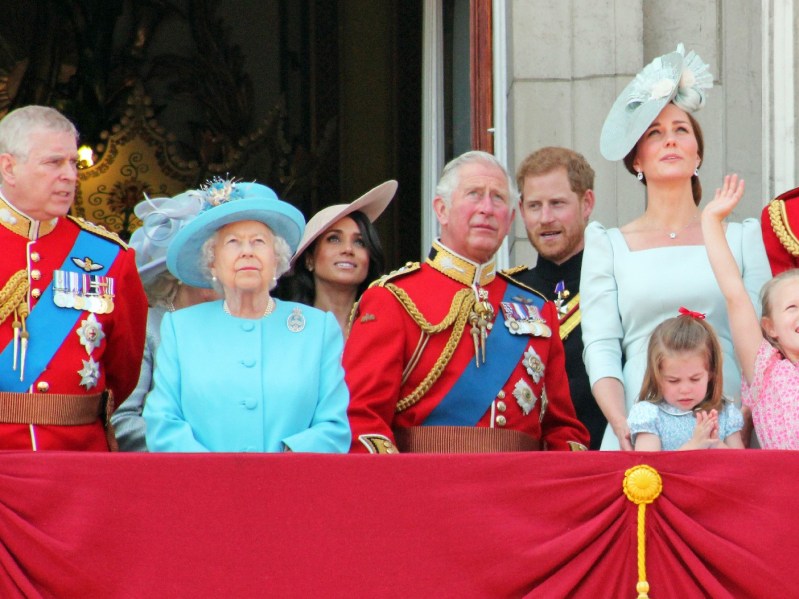Members of the royal family stand together on a balcony during a royal event