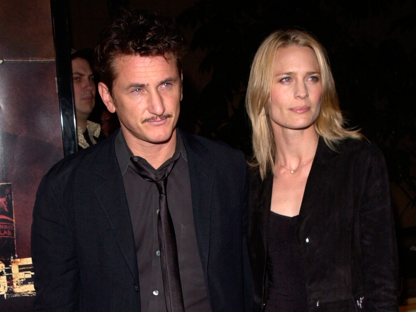 Sean Penn and Robin Wright walk together on the red carpet, both dressed in dark colors